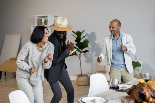 African Lovin' celebrating a successful thanksgiving. stock image of three people dancing, turkey on dining table